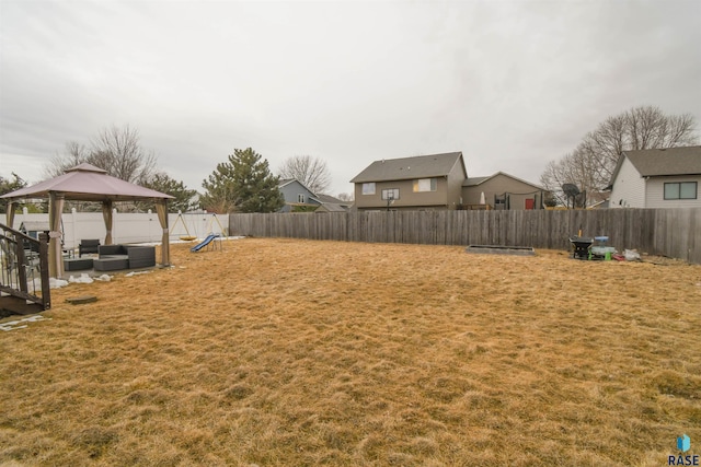 view of yard featuring a fenced backyard, outdoor lounge area, and a gazebo