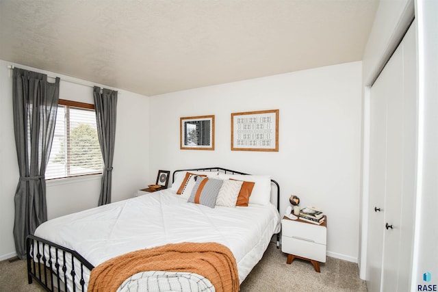 bedroom with light carpet, a closet, and baseboards