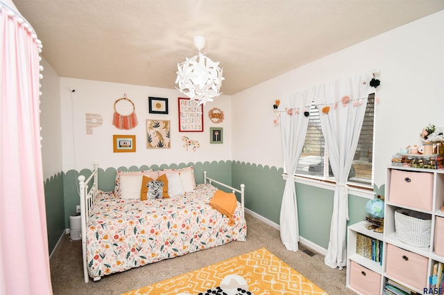 bedroom featuring a notable chandelier, carpet flooring, visible vents, and baseboards