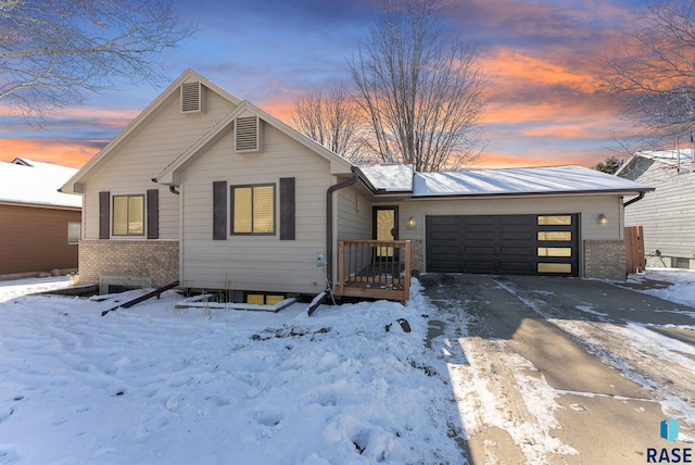 view of front of property with an attached garage, driveway, and brick siding