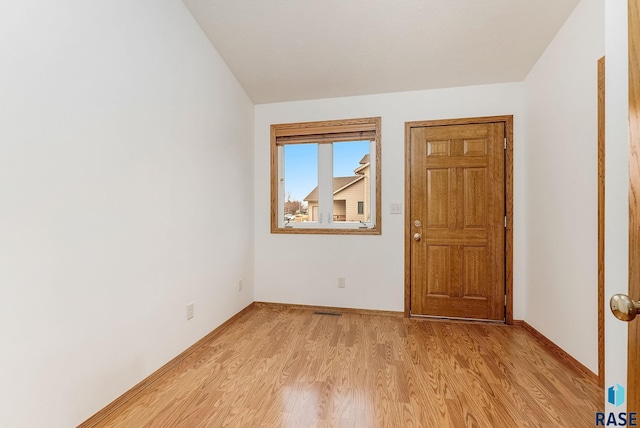 interior space with light wood finished floors and baseboards