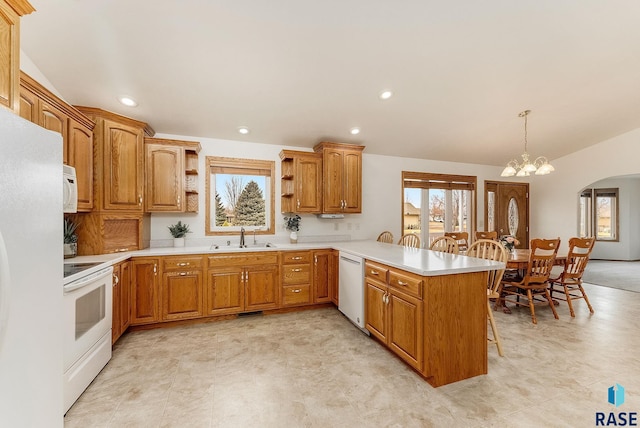 kitchen with light countertops, hanging light fixtures, a peninsula, and open shelves