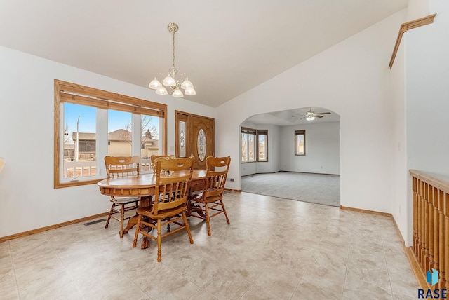 dining area featuring arched walkways, high vaulted ceiling, baseboards, and an inviting chandelier