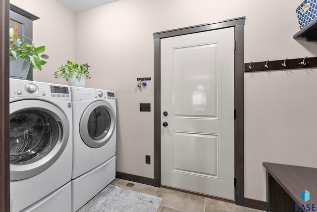 laundry area with baseboards, laundry area, and washer and dryer