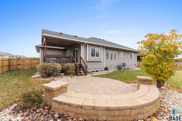 back of house with a lawn, a patio, a fenced backyard, a gate, and cooling unit