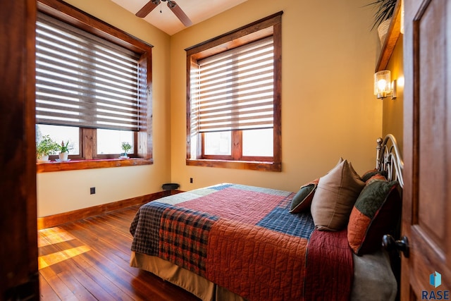 bedroom with wood finished floors, a ceiling fan, and baseboards