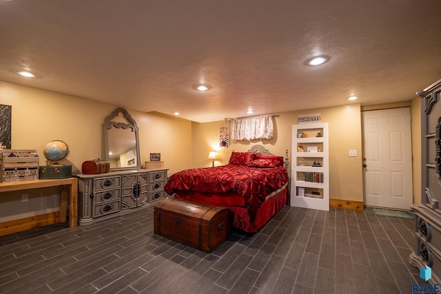 bedroom featuring a textured ceiling, recessed lighting, and wood tiled floor