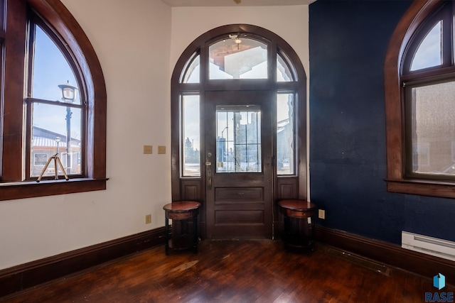 entryway with dark wood-style floors, a baseboard radiator, and baseboards