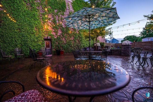 view of patio / terrace featuring outdoor dining area and fence