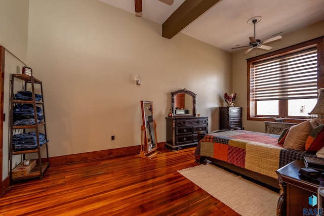 bedroom featuring ceiling fan, beam ceiling, baseboards, and wood finished floors