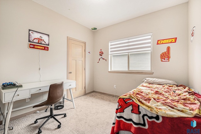 bedroom with baseboards and light colored carpet