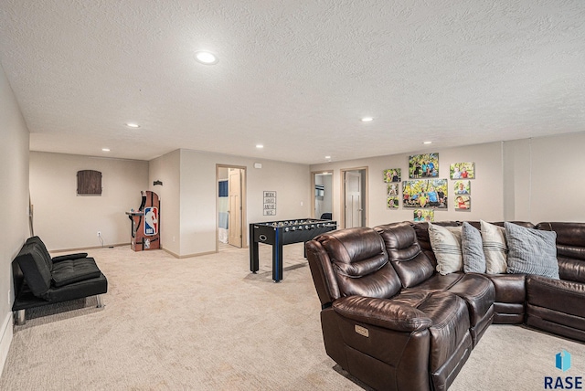 living area with light carpet, a textured ceiling, baseboards, and recessed lighting