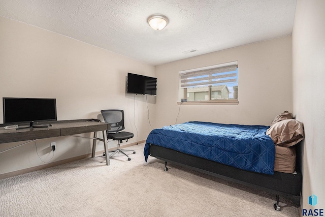 bedroom featuring baseboards, a textured ceiling, and light colored carpet