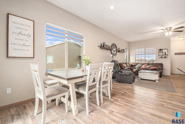 dining room featuring light wood finished floors, a ceiling fan, and baseboards