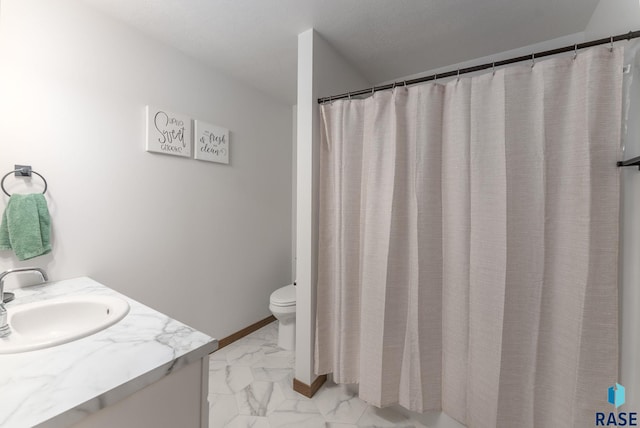 bathroom featuring marble finish floor, toilet, vanity, and baseboards