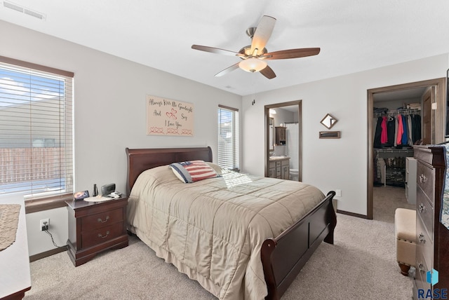 bedroom featuring light colored carpet, visible vents, baseboards, a spacious closet, and a closet