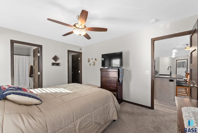 bedroom with light colored carpet, ceiling fan, and baseboards