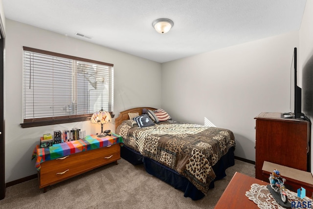 bedroom with light colored carpet, visible vents, and baseboards