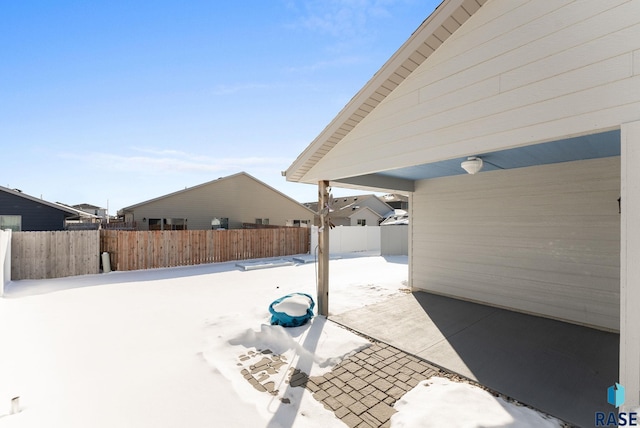 snow covered patio with fence