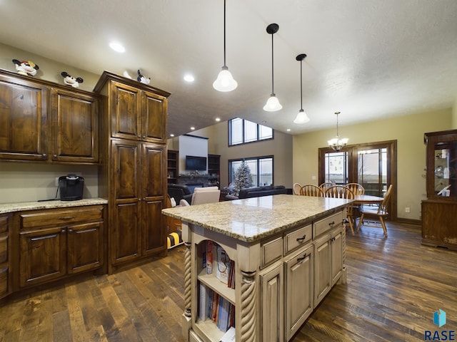 kitchen with light stone countertops, dark wood-type flooring, a center island, open shelves, and pendant lighting