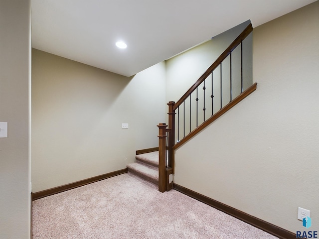 stairs with carpet, baseboards, and recessed lighting