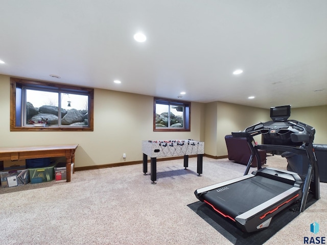 workout room with baseboards, recessed lighting, and light colored carpet