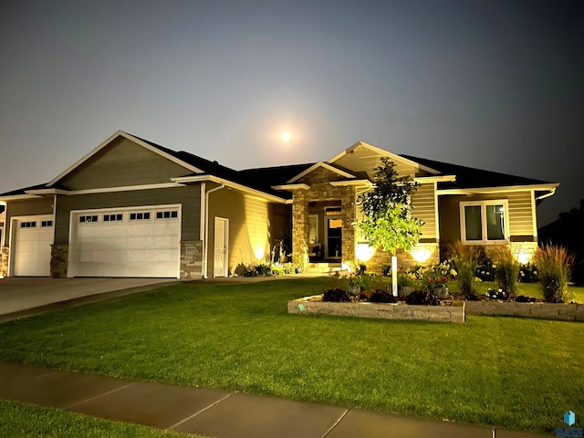 view of front of property featuring an attached garage, stone siding, and a front yard