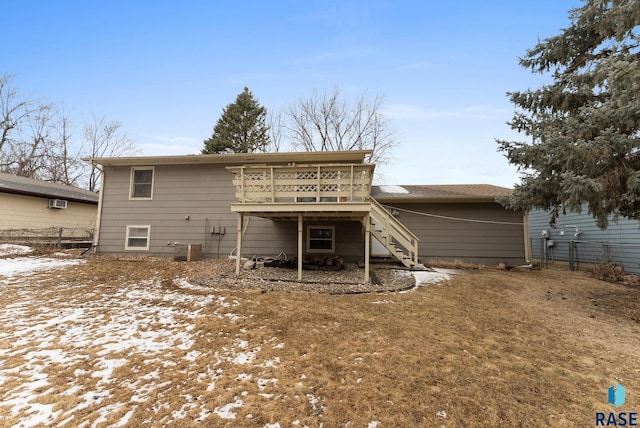 snow covered property featuring central air condition unit, stairs, fence, and a deck