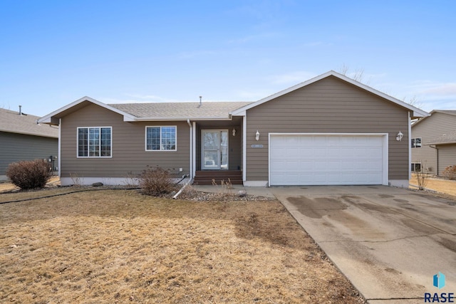 ranch-style house with an attached garage, a shingled roof, and concrete driveway