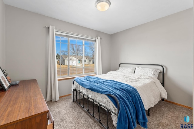 bedroom featuring carpet floors and baseboards