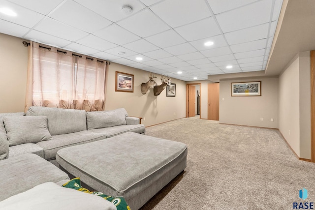 living area featuring baseboards, a drop ceiling, carpet flooring, and recessed lighting