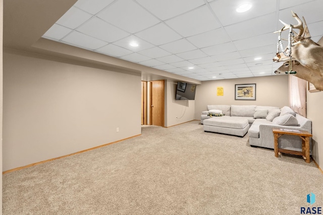 unfurnished living room with recessed lighting, carpet flooring, a paneled ceiling, and baseboards