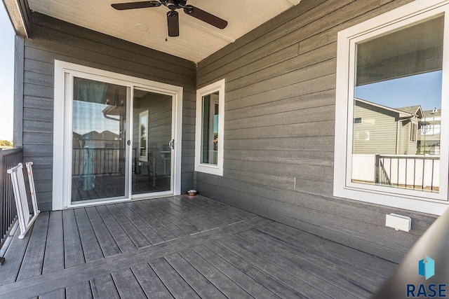 wooden terrace featuring a ceiling fan