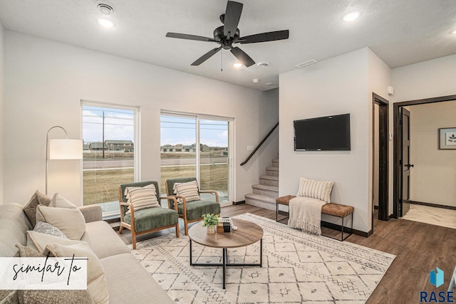 living area featuring ceiling fan, recessed lighting, wood finished floors, baseboards, and stairs