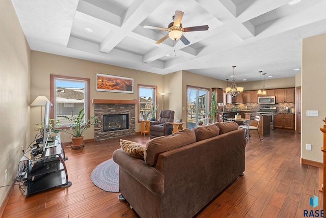 living room featuring dark wood-style floors, a fireplace, coffered ceiling, and baseboards