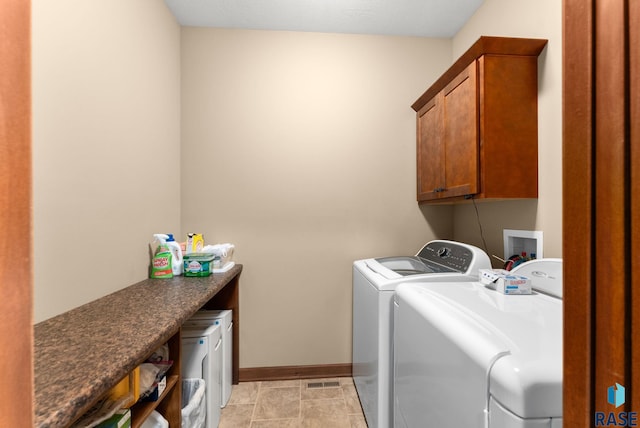 laundry area with cabinet space, baseboards, and separate washer and dryer