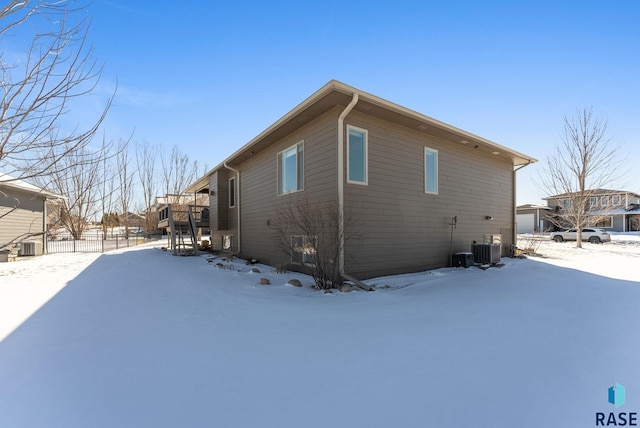 view of snowy exterior featuring fence