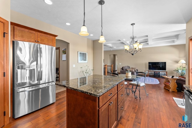 kitchen featuring coffered ceiling, a kitchen island, open floor plan, stainless steel fridge with ice dispenser, and dark wood-style floors