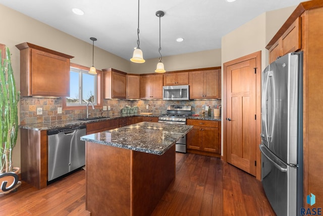 kitchen featuring appliances with stainless steel finishes, dark wood-style flooring, a sink, and brown cabinetry