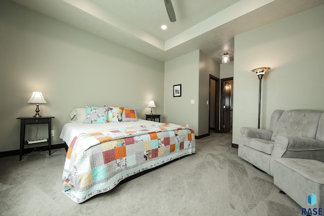 bedroom with light colored carpet, ceiling fan, and baseboards