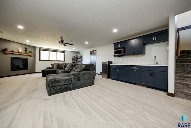 living area featuring recessed lighting, light colored carpet, baseboards, stairs, and indoor wet bar