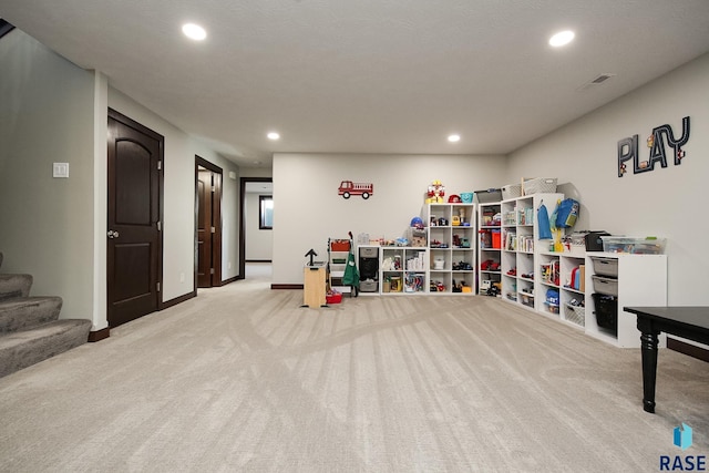 interior space featuring stairs, baseboards, light colored carpet, and recessed lighting