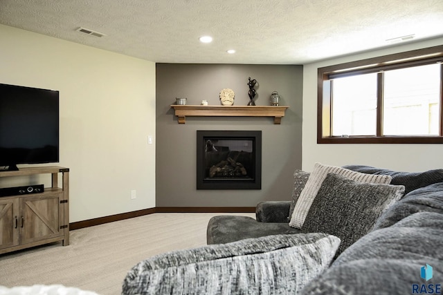 living room featuring light colored carpet, visible vents, a textured ceiling, and baseboards