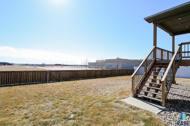 view of yard featuring fence private yard and stairs