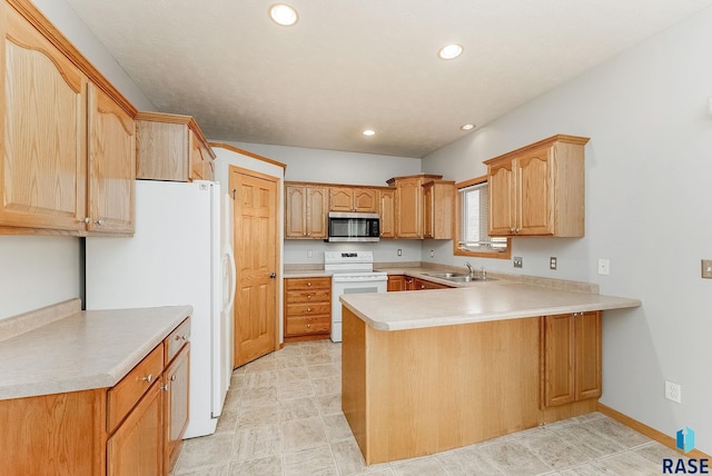 kitchen featuring recessed lighting, light countertops, a sink, white appliances, and a peninsula