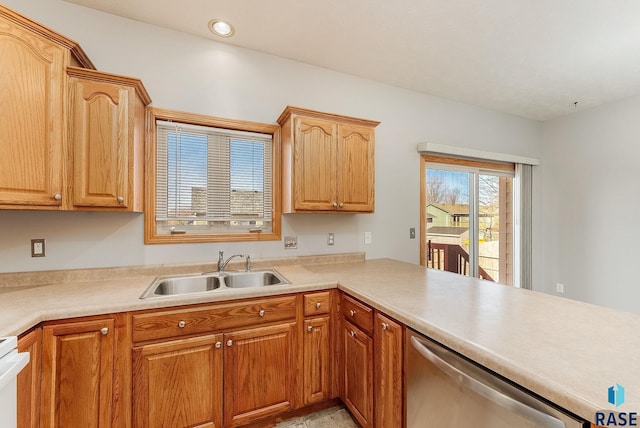 kitchen with recessed lighting, a peninsula, a sink, light countertops, and stainless steel dishwasher