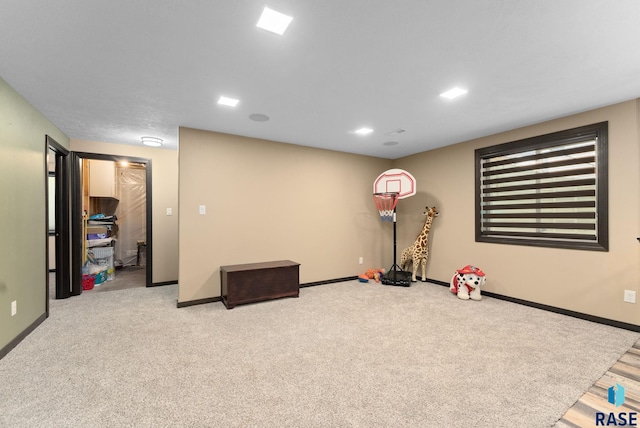 game room with light carpet and baseboards