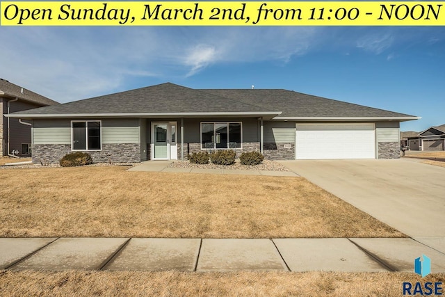 view of front facade featuring stone siding, a front lawn, an attached garage, and driveway