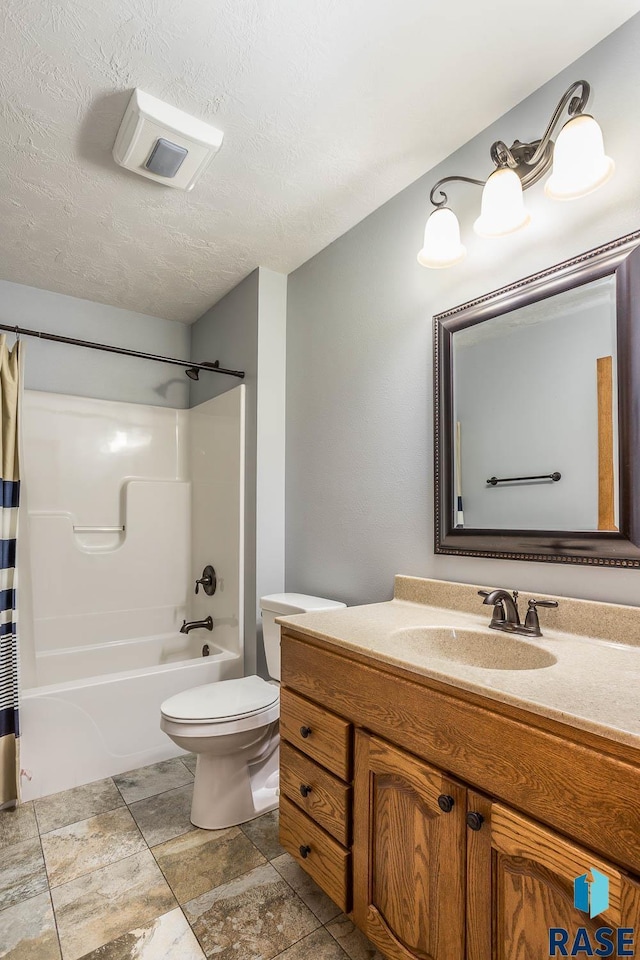 full bathroom with shower / tub combo with curtain, a textured ceiling, toilet, and vanity