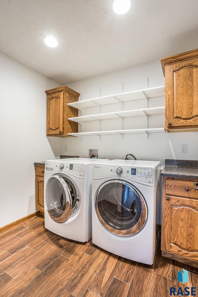 washroom featuring wood finish floors, recessed lighting, cabinet space, independent washer and dryer, and baseboards